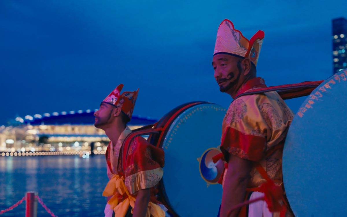 Tibetan Buddhist monks waiting behind the stage at the Outdoor Theatre at Esplanade.